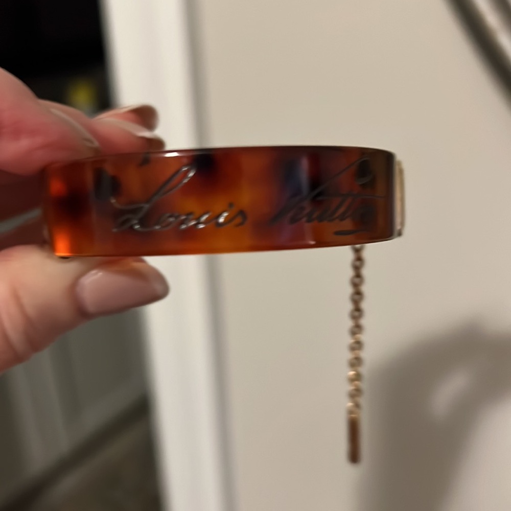 Louis Vuitton ResinTortoise bracelet with signature.